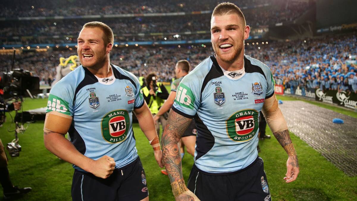 Dragons teammates Trent Merrin and Josh Dugan celebrate after the Blues sealed the State of Origin series by beating Queensland on Wednesday night. Picture: GETTY IMAGES


