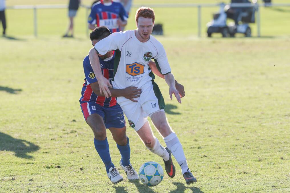 Bellambi's Jacob Fryday tangles with Woonona's Pat Marales during the match at Ocean Park on June 7. Picture: ADAM McLEAN