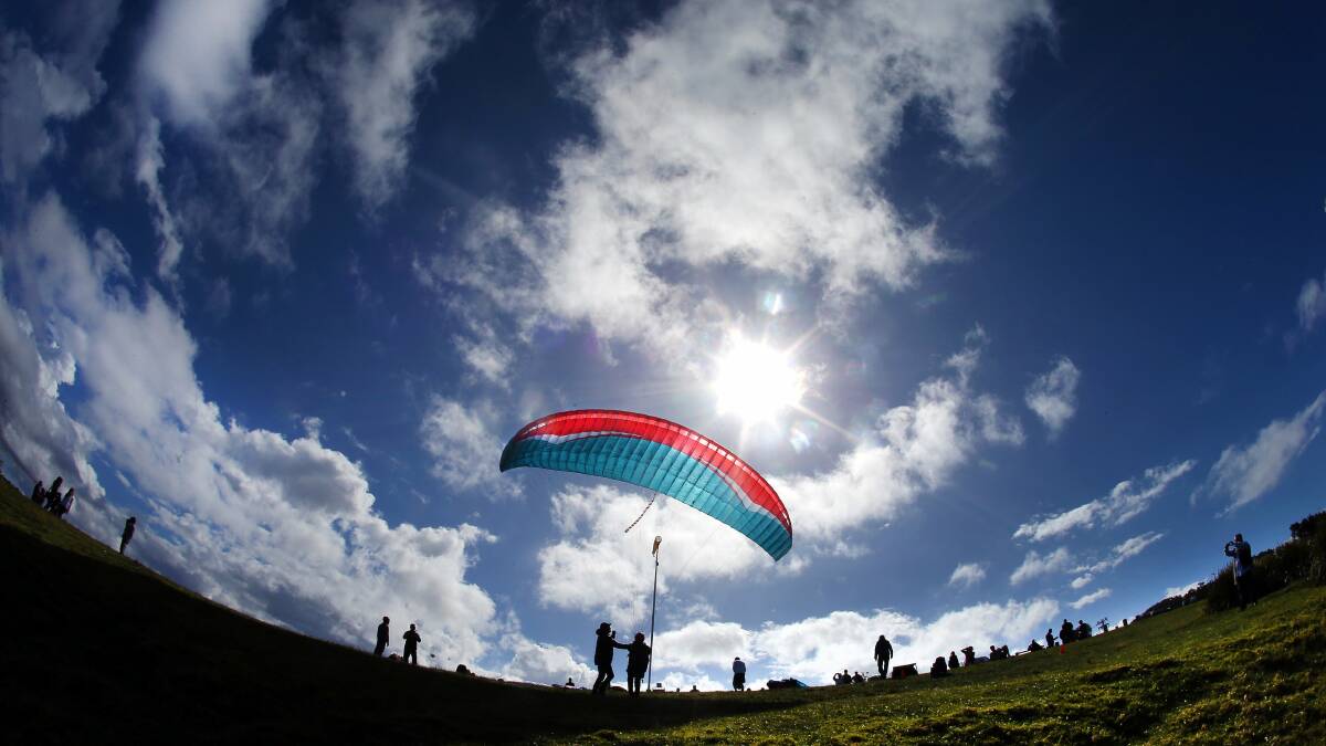Instructor Antony Prehn from Adventure Plus Paragliding prepares Kristen McKenna for take off from Bald Hill at Stanwell Park. Pictures: KIRK GILMOUR