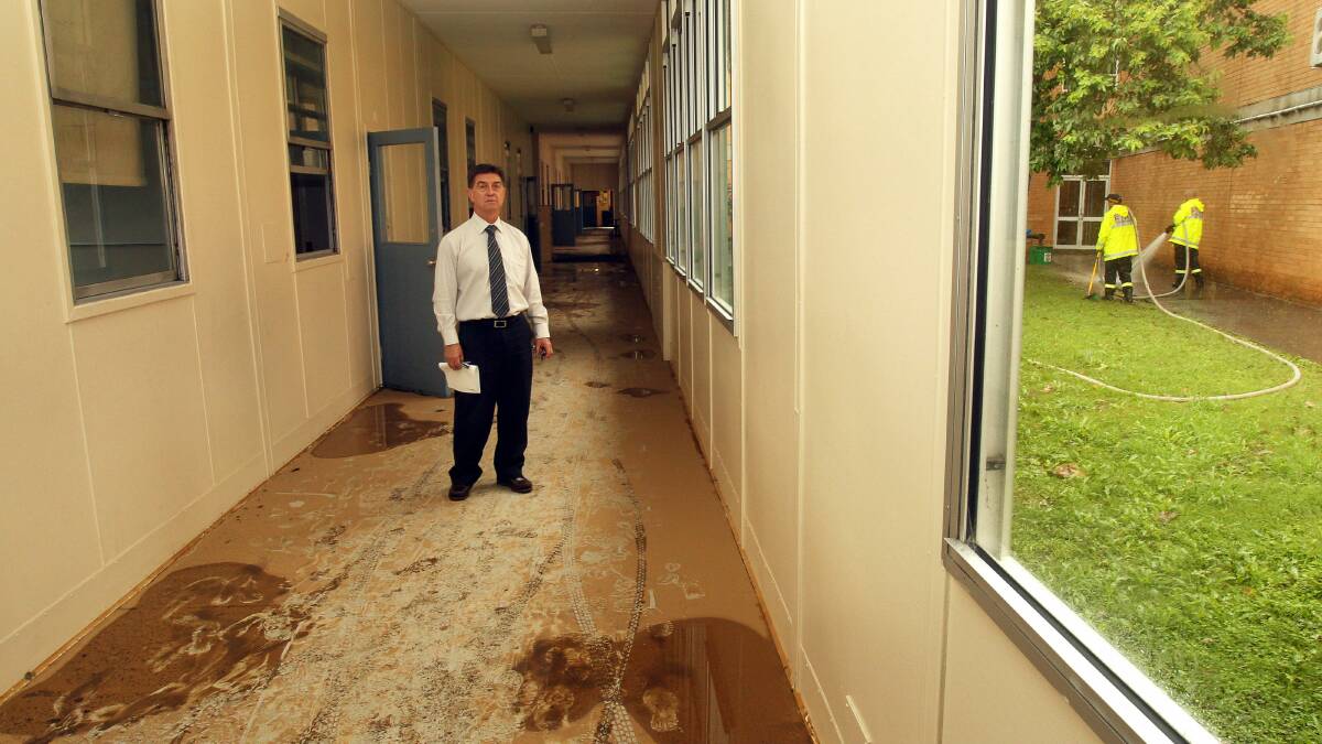 Bulli High School principal Lou Tome in a flood-hit school building. Picture: KIRK GILMOUR