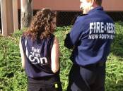 Mercury reporter Gemma Khaicy, standing with a firefighter on demolition day, in her Port stack T-shirt.