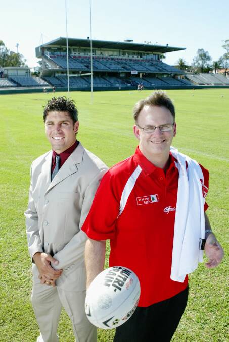 Dragons captain Trent Barrett suits up at Kogarah, while Federal Opposition Leader Mark Latham, a long-term Dragons fan, opts for training gear.