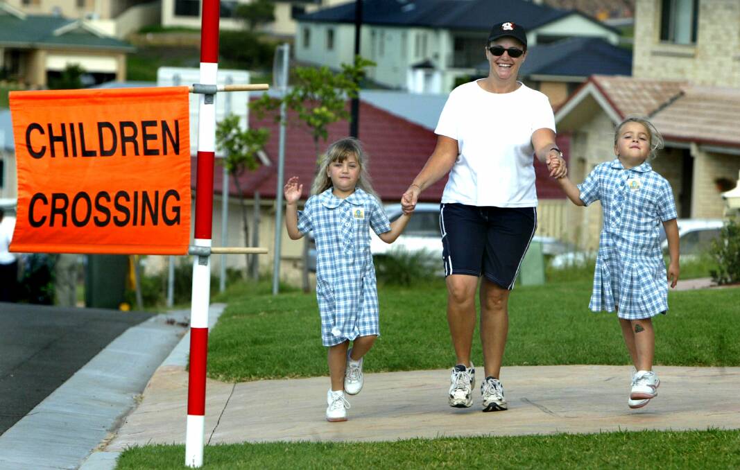 Flinders Public School students Lauren and Brooke enlist the support of mother Kate on Walk Safely to School Day.