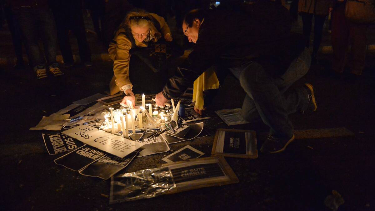 People gather around candles and pens at the Place de la Republique in support of the victims. Picture: GETTY IMAGES