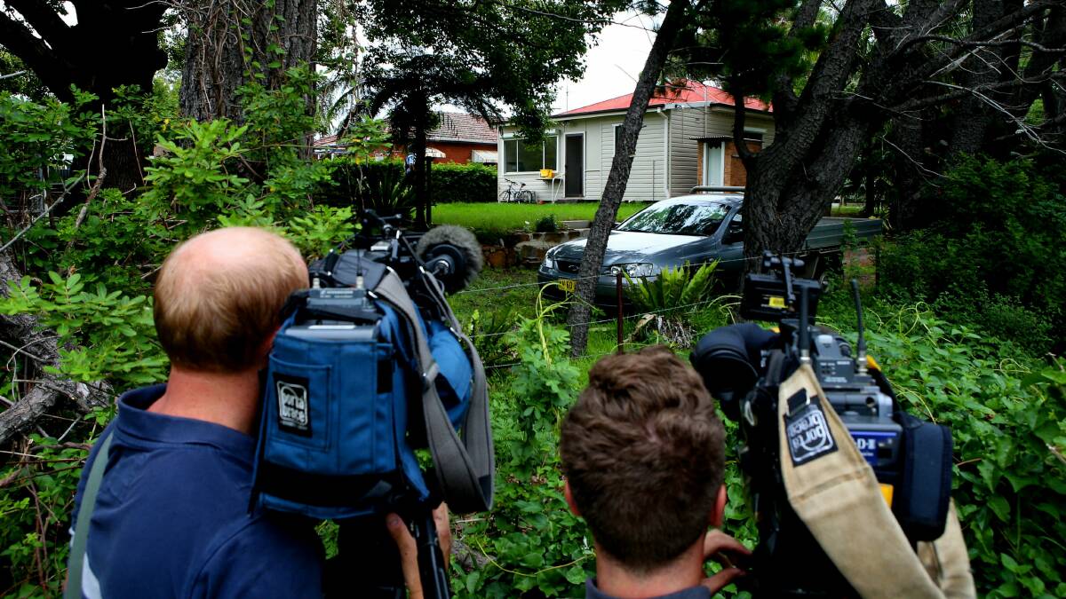 News crews at the back of the Bulli house where a woman's body was found on Friday. Picture: KIRK GILMOUR