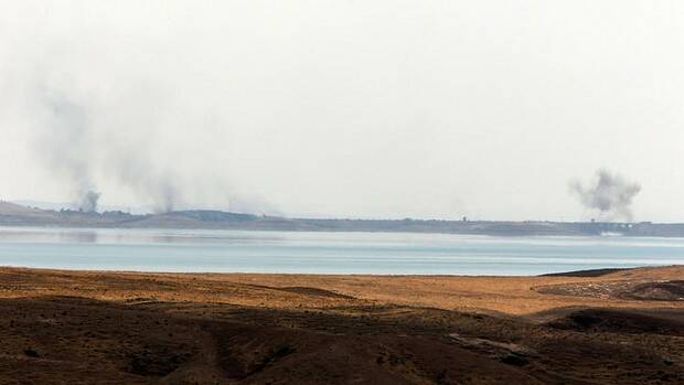 Smoke rises following US air strikes on Islamic State militants at Mosul Dam on Monday. Picture: AFP