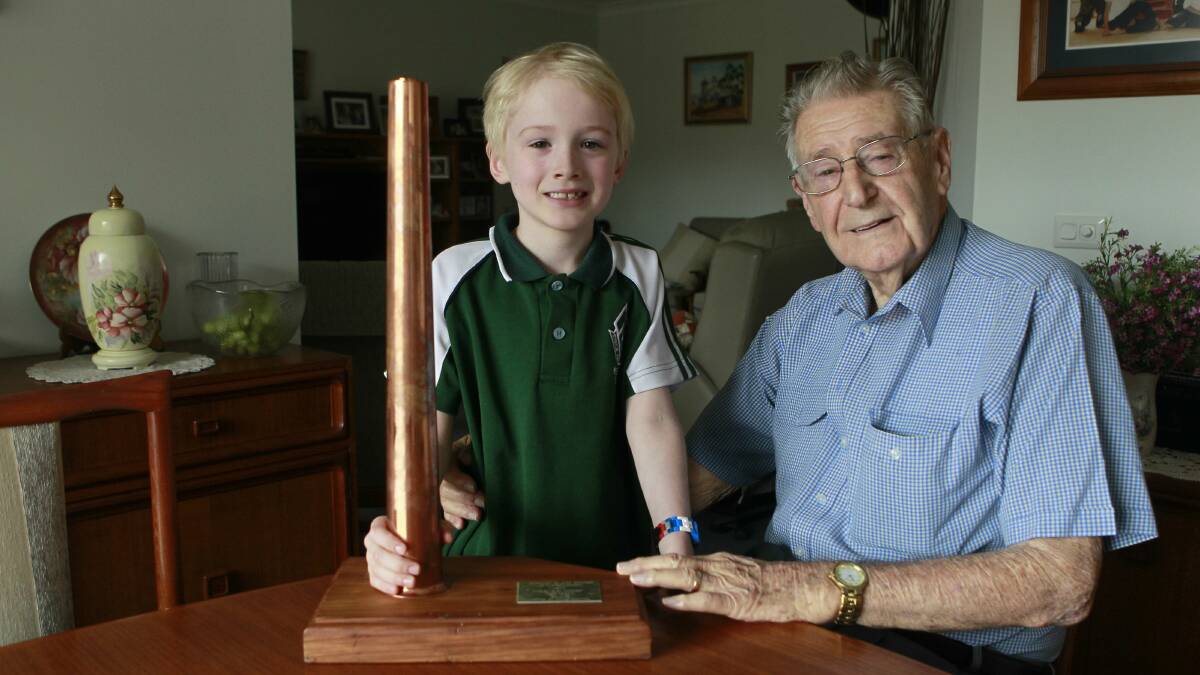 Boyd Thompson gives his great-grandson Angus, 6, the copper stack he received when he retired. Picture: CHRISTOPHER CHAN