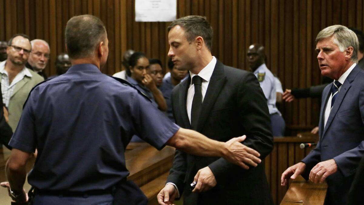 Oscar Pistorius is led out of court after he received a five-year prison sentence for culpable homicide. Picture: AP