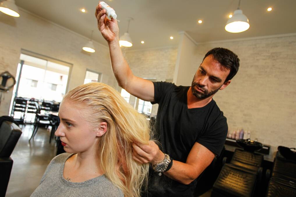  Peter Thomsen working on Enya Smith's hair in his salon. Picture: CHRISTOPHER CHAN