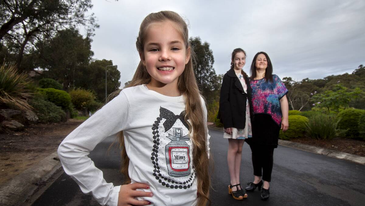 Keelin O'Reilly, 8, with mother Sarah and sister Morgan, 13. Picture: LUIS ENRIQUE ASCUI 
