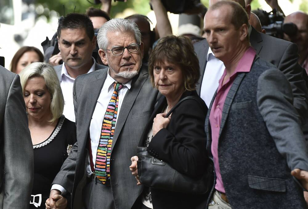 Rolf Harris arrives at court with his daughter Bindi, left, and niece Jenny. Picture: REUTERS