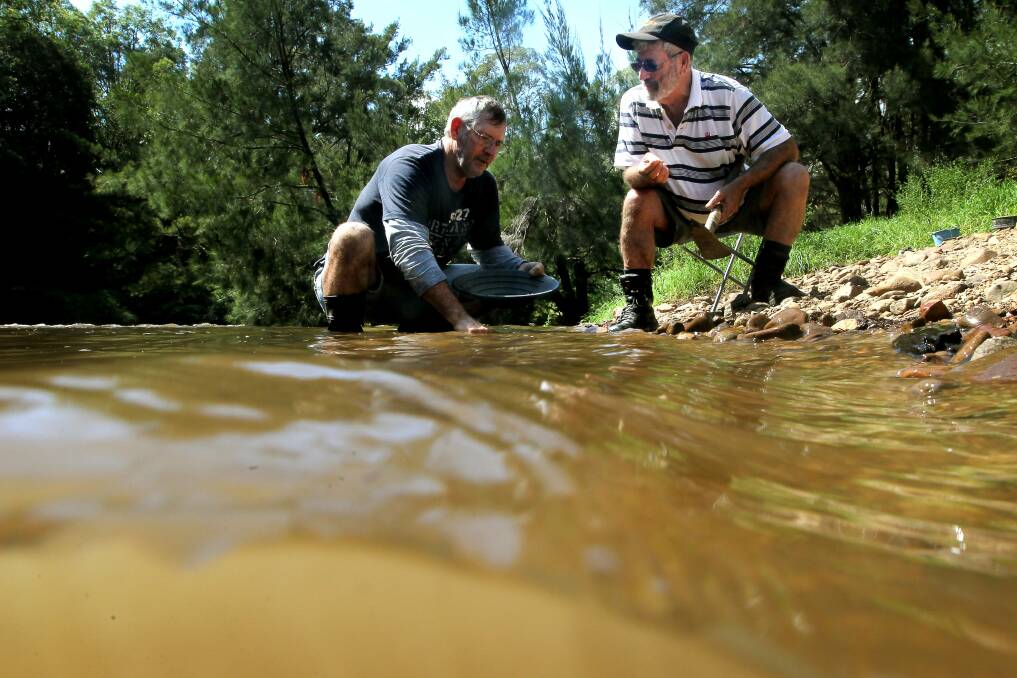 Adam and Ross Langland discuss gold-panning techniques. Picture: SYLVIA LIBER