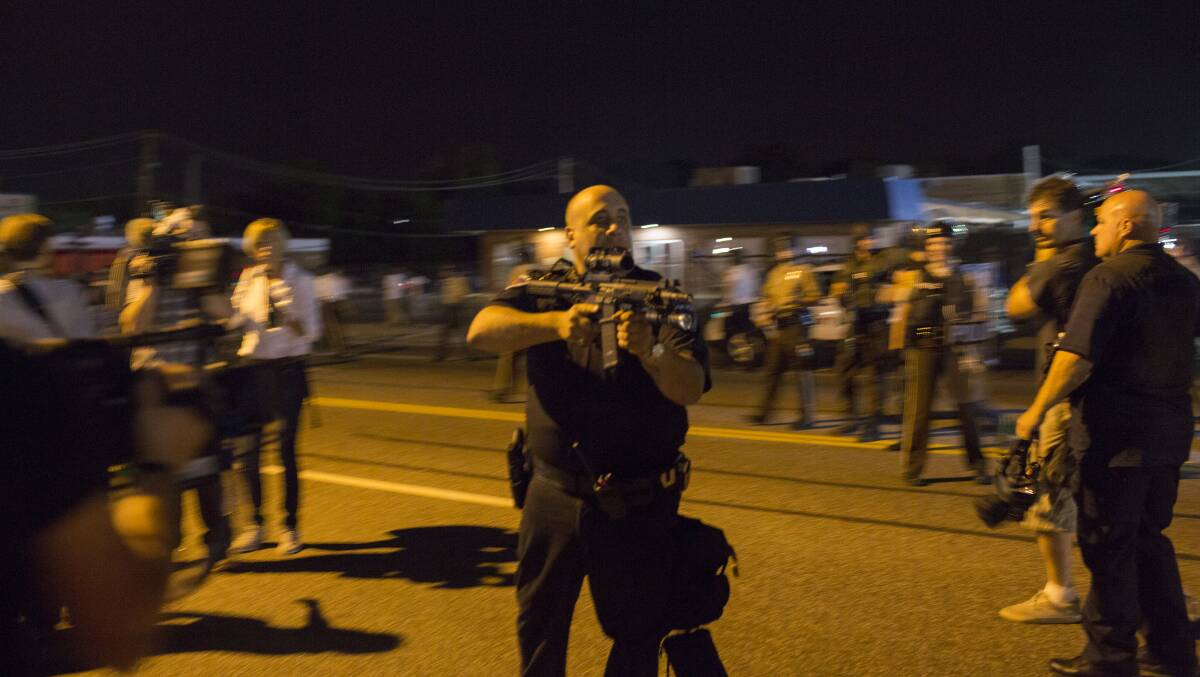 Missouri police officer Ray Albers points an assault rifle at a protester. Picture: GETTY IMAGES