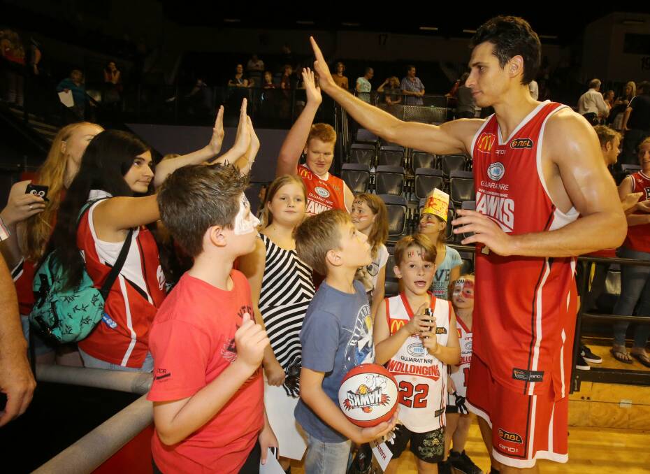 Hawks players get a high-five from fans after their NBL season comes to an end. Picture: ROBERT PEET