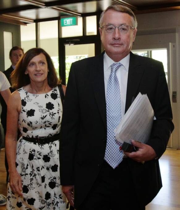 Team Swan: Leaving the National Press Club with his wife Kim in 2012.