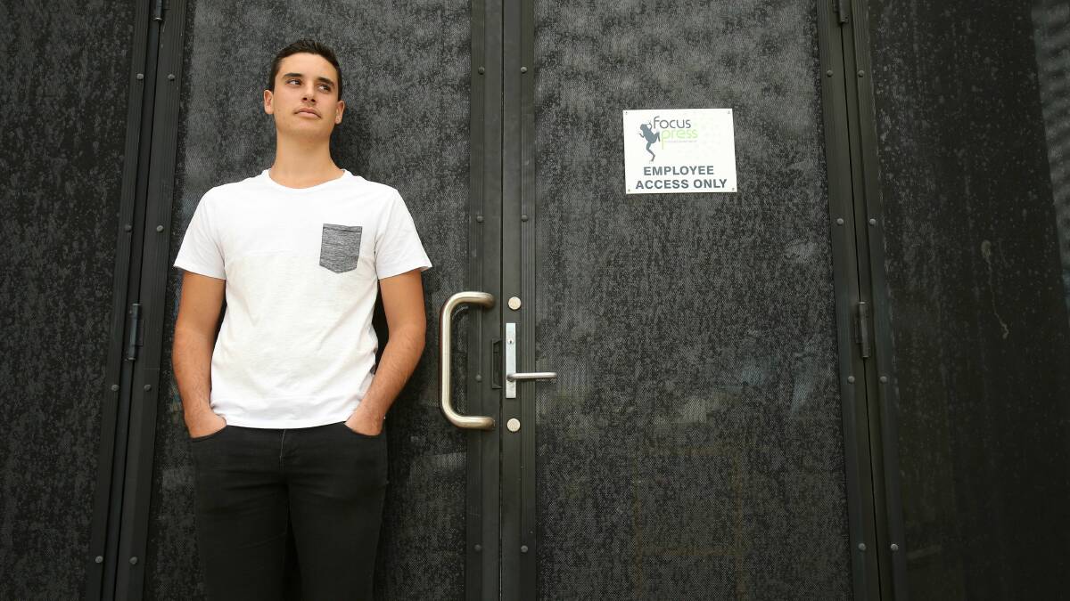 Jake Gonzalez, of Port Kembla, stands outside his former workplace, Focus Press in Kemblawarra. Picture: KIRK GILMOUR