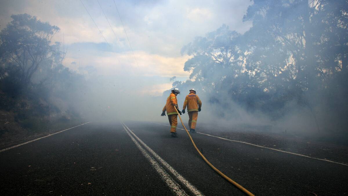 Rural Fire Service volunteers control a backburn near a large bushfire burning in the Mt Victoria area of the Blue Mountains. 