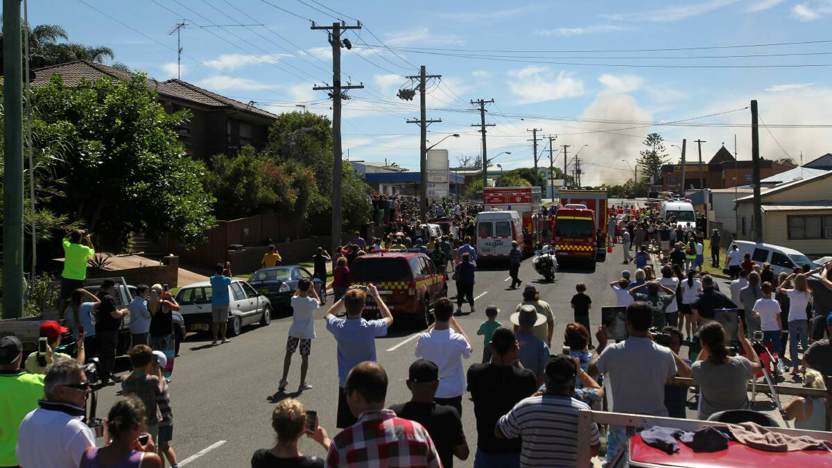 Watching the stack fall on Church Street in Port Kembla. Picture: GREG TOTMAN