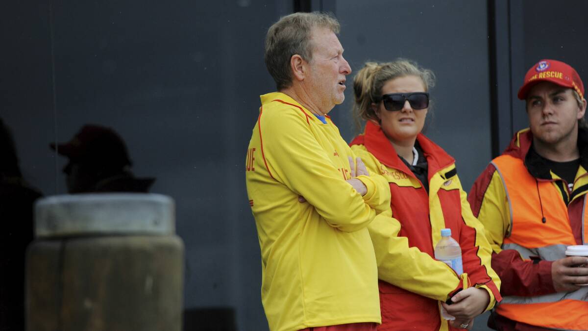Christine Armstrong’s husband Rob with surf lifesavers on Friday. Picture: GRAHAM TIDY