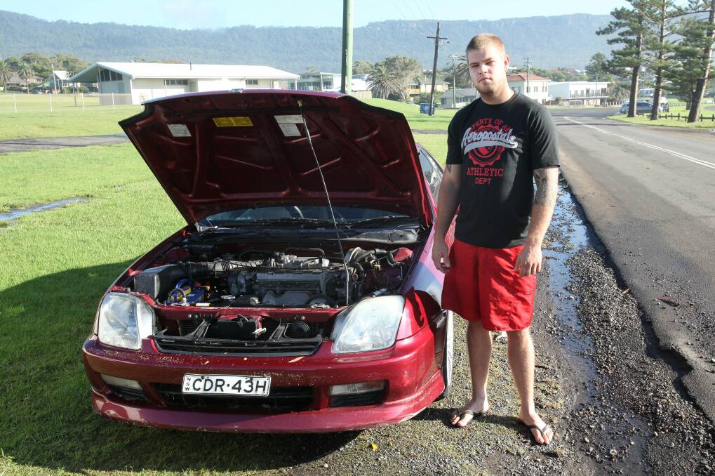  Kyle Mayo of Tarrawanna with his car at Bulli Park on Tuesday morning. The car got stuck in one-metre high floodwaters on Trinity Row at 1.30am. Picture: KIRK GILMOUR