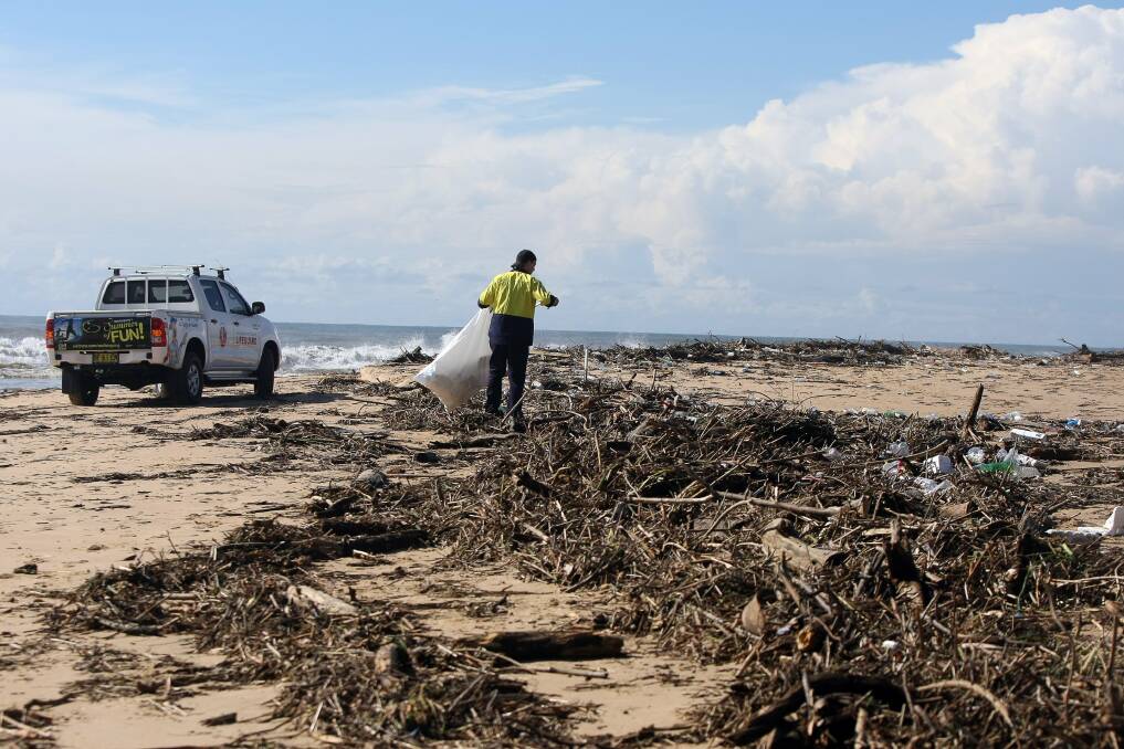Huge mounds of debris and rubbish litter North Wollongong Beach in the wake of last night's heavy rain and flooding. Picture: SYLVIA LIBER