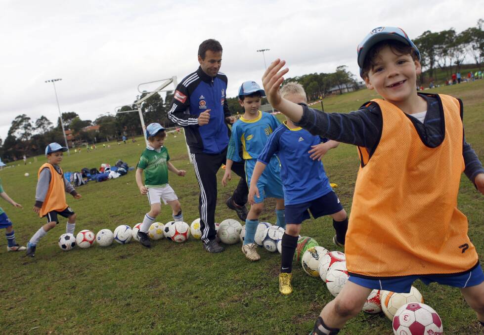 Football fun: Former Wolves premiership winner  Paul Reid at a junior clinic in 2013. Football South Coast clubs are holding their 2015 registration days over the next two Saturdays. Picture: ANDY ZAKELI
