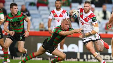 Dragons player Josh Dugan evades the South Sydney defence during the loss at ANZ Stadium on Monday. Picture: GETTY IMAGES