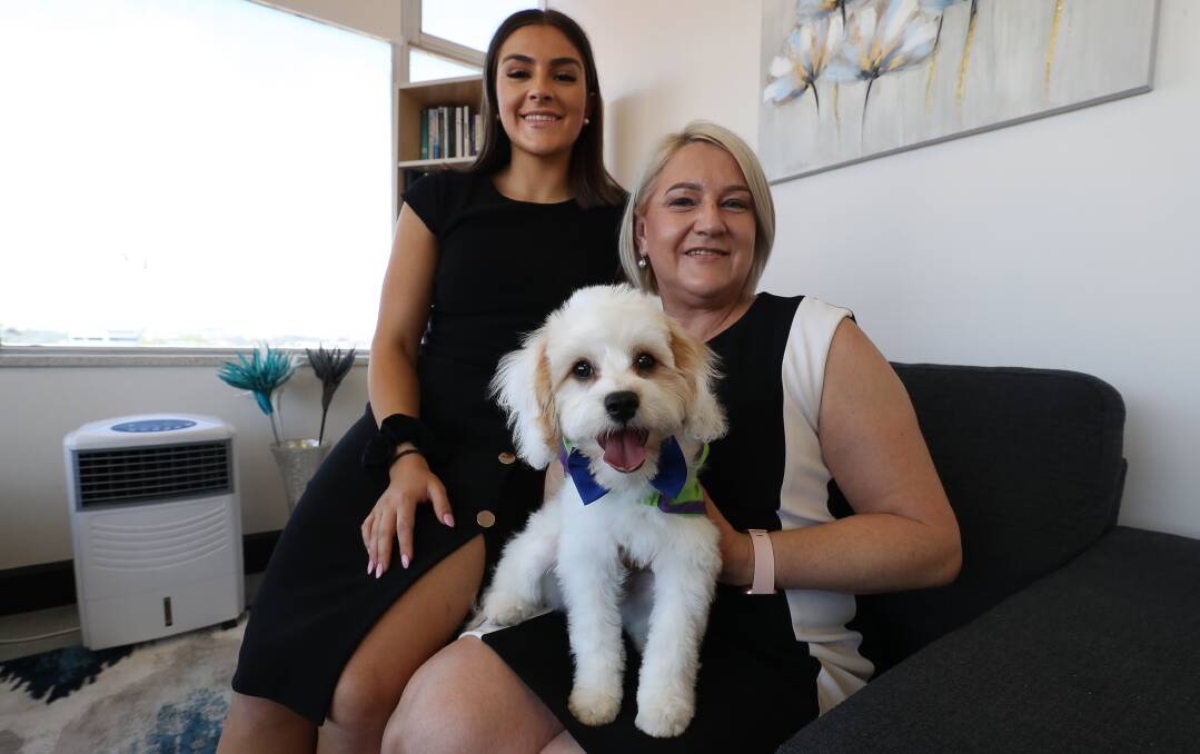 Psychologist's best friend: Chloe Lavalle, Dr Olga Lavalle and Dre the Toy Cavoodle, who is being trained as a therapy dog at her Wollongong psychology clinic. Picture: Robert Peet.
