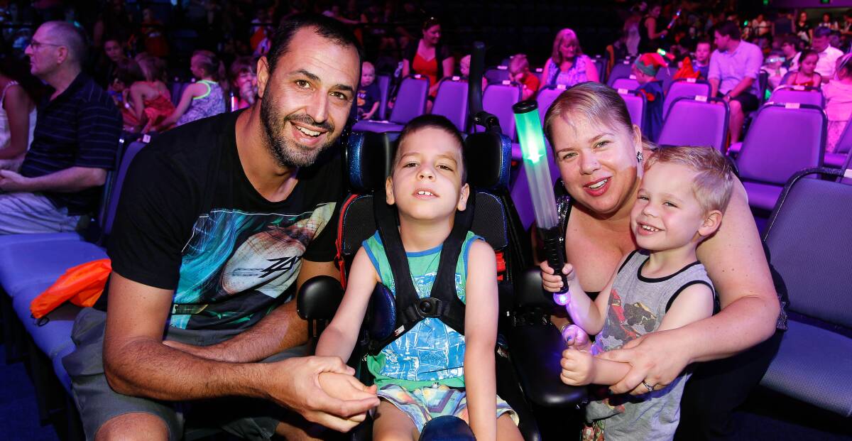 Wonderful day: Grant, Dane, Sally and Cooper Robinson enjoy the KidzWish Christmas show put on for thousands children in Wollongong. Picture: Sylvia Liber

