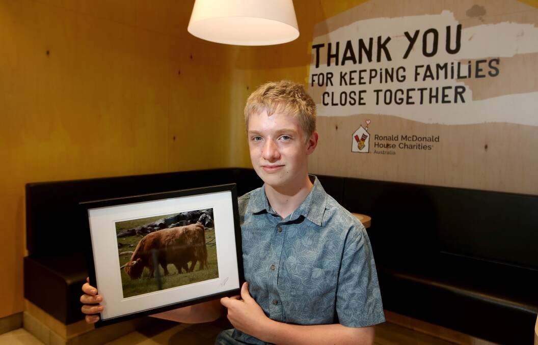 Giving back: Luke Turnbull, 13, with one of the photos from his Winter Expressions exhibition for the charity that helped him in hospital, Ronald McDonald House. Picture: Sylvia Liber.