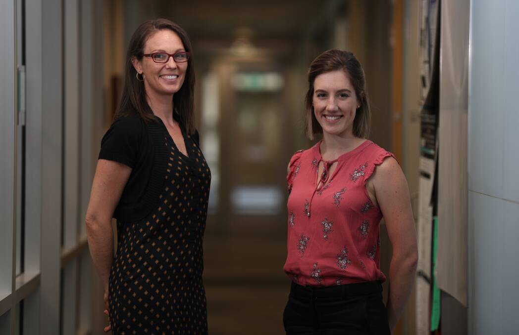 Mentor and mentee: Senior research fellow Dr Kara Vine-Perrow with NSW Young Women of the Year Dr Samantha Wade at IHMRI. Picture: Robert Peet.