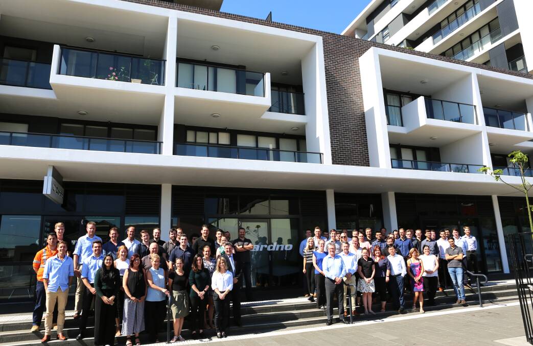 New home: Some of Cardno's 120 strong Wollongong workforce outside the company's new South Coast office in Burelli Street. Picture: Greg Ellis.

