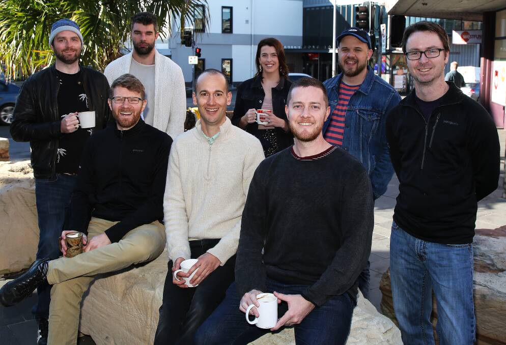 Jobs growth sector: Nick Muldoon (second left) and Dave Elkan (fourth left) with some of their team enjoying a morning coffee from Tally Ho in lower Crown Street Mall, Wollongong. Picture: Greg Ellis.
