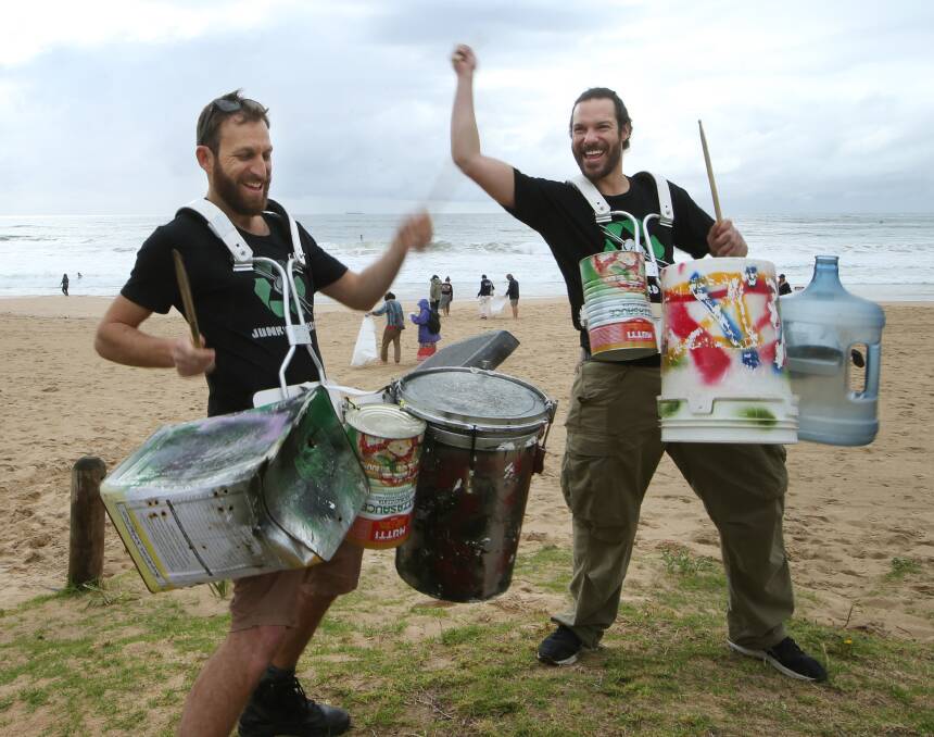 In tune with a clean beac: Oded Prior and Theo Fontes, of Junkyard Beats, motivate those cleaning North Beach with music made on recycled instruments. Picture: Sylvia Liber.
