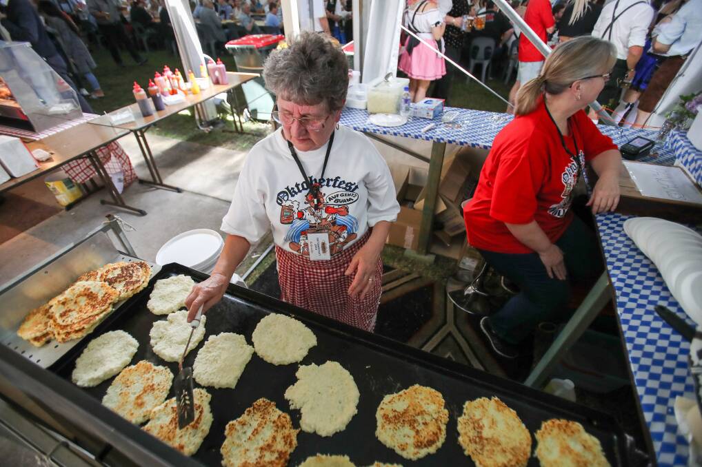Plenty of food: Rolande Bernard cooking German pancakes during Oktoberfest on a busy Saturday afternoon at Kembla Grange.

