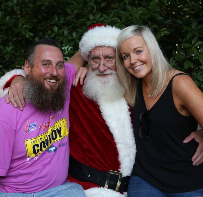 Master's apprentice: Justin Beasley and Michelle Cuneo get the nod from Santa Claus before Mr Beasley had his beard shaved off at Mount Kembla Village Hotel to help Camp Quality cancer kids. Picture: Greg Ellis