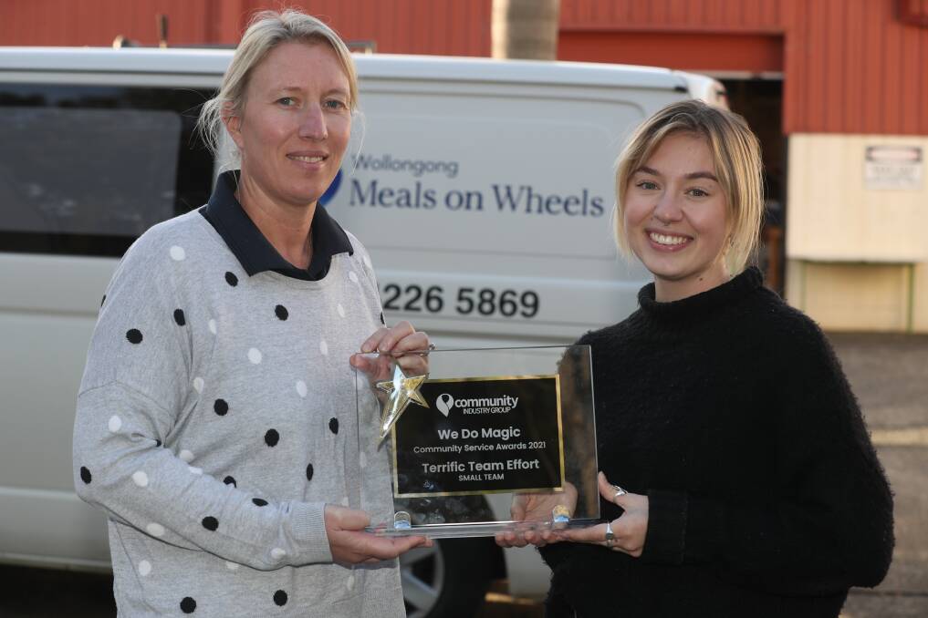 Recognition: Sarah Callaway and Rhiannon Lincoln of Meals on Wheels with their Illawarra Community Awards trophy. Picture: Robert Peet.