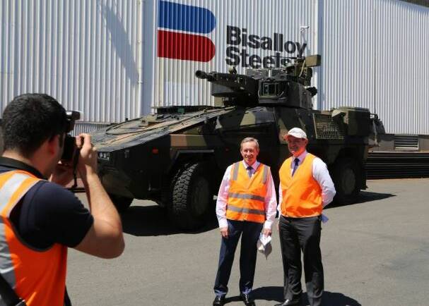 Business allies: Bisalloy Steel Group's Greg Albert and Rheinmetall Defence Australia's Gary Stewart on a visit to the Unanderra plant in 2017 to update Bisalloy employees about their involvement in its bid for the biggest and most expensive acquisition program in the Australian Armys history.. Picture: Greg Ellis. 