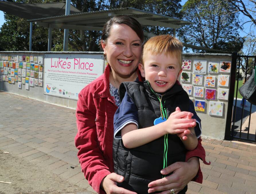Big honour: Rita Rapley, holding her son Luke, was named 2014 Corrimal citizen of the year along with her husband Sean. Picture: GREG ELLIS
