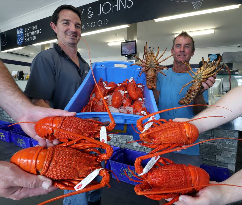 Staying loyal: Grant Logue from Harley & Johns Seafood with commercial fisherman Mark Maher and some of his local lobster catch. Pictures: Robert Peet.