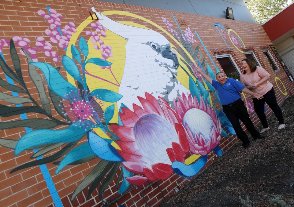 Artwork activation: Spring Into Corrimal chair Paul Boultwood and Cr Jenelle Rimmer check out the new giant mural at Corrimal Library. Picture: Robert Peet. 