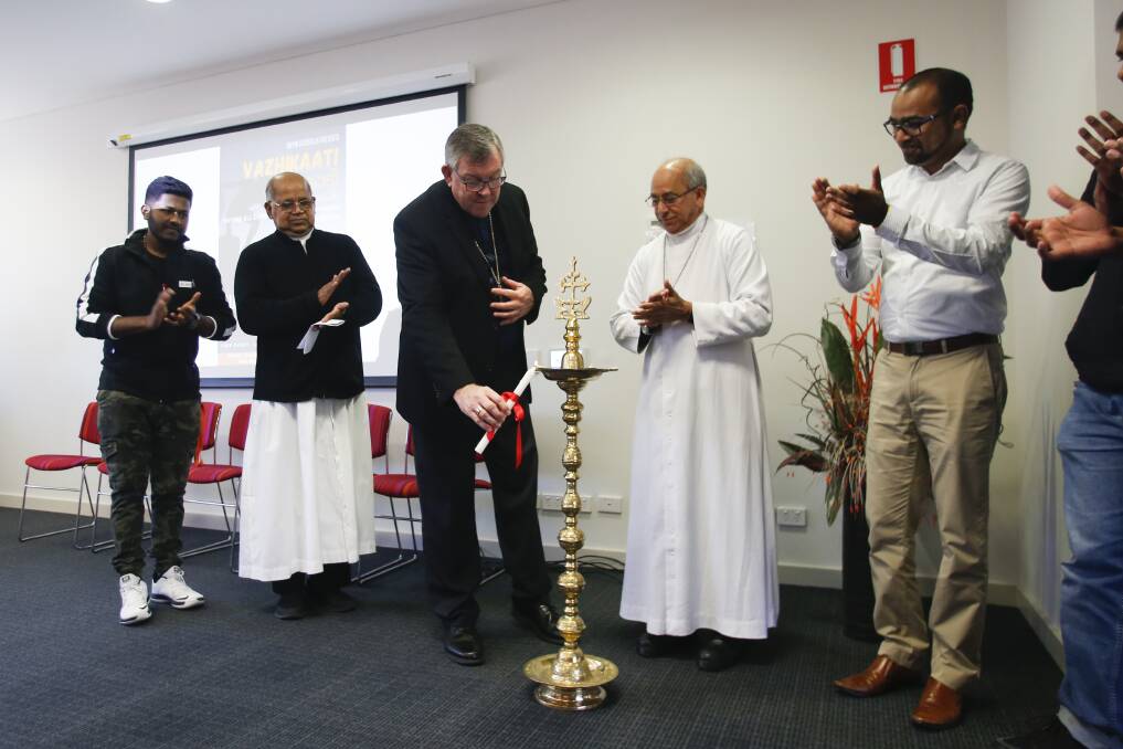 Opening: Bishop Brian Mascord and Bishop Bosco Puthur take part in a candle lighting ceremony to start the day long event in Wollongong. Picture: Anna Warr.