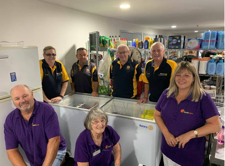 Food relief: Foodcare's Brad Jenkins, Ruth Jacobson and Karen Mathews (front row) with Rotarians Tracy Wicks, Ray Tarlinton, Pat Giles and Larry How (back row) and the new freezer the Rotary Club of Shellharbour helped buy.
