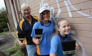 Dapto Rotarian Mick Chamberlain and some young Graffiti Removal Day volunteers from the Girl Guides.
