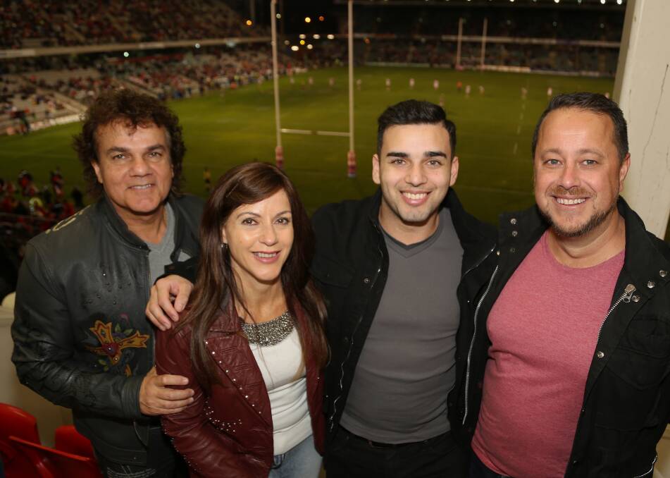 Winning ways: Glenn, Katia and James Dwarte celebrate the eve of taking over their fourth store in the Illawarra with NSW/ACT McDonald's franchise manager Clinton Smith with a Dragons win at the football on Thursday night.
