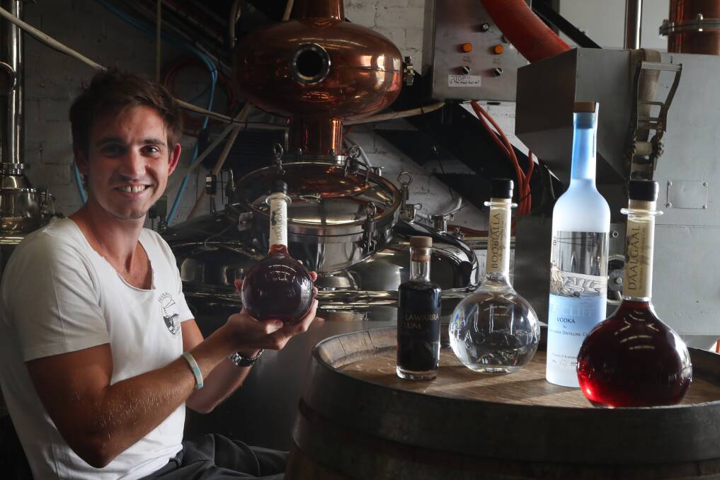 Lifting Illawarra spirits: Dean Martelozzo with the international silver and bronze medal winning spirits Headlands Distilling Company makes in Ralph Black Drive. Picture: Robert Peet.