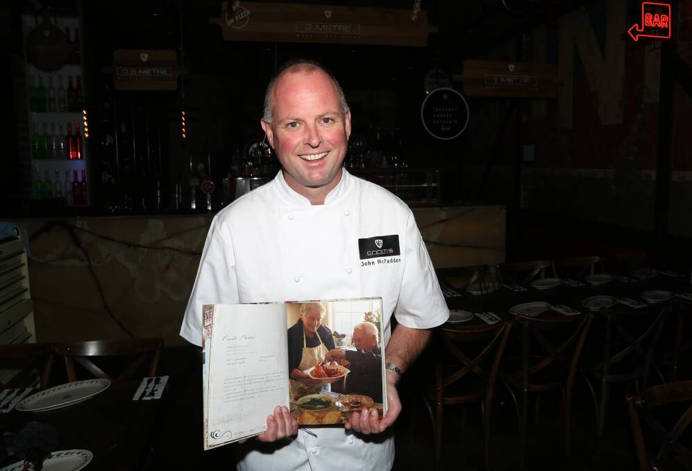 Head chef throws out a Wollongong challenge: Criniti's executive chef John McFadden with a book of some of the favourite Criniti family recipes. Picture: Greg Ellis.
