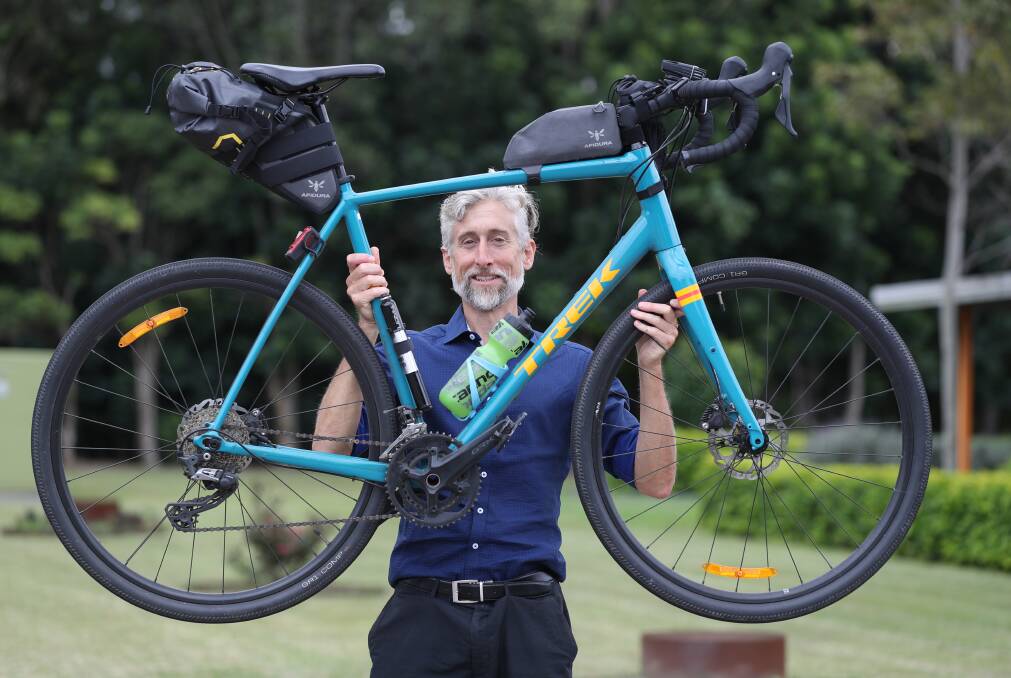 Solo man: The Disability Trust chief operating officer Ed Birt still had energy to lift his bike on Wednesday after riding from Canberra to Coniston before work. Picture: Robert Peet.
