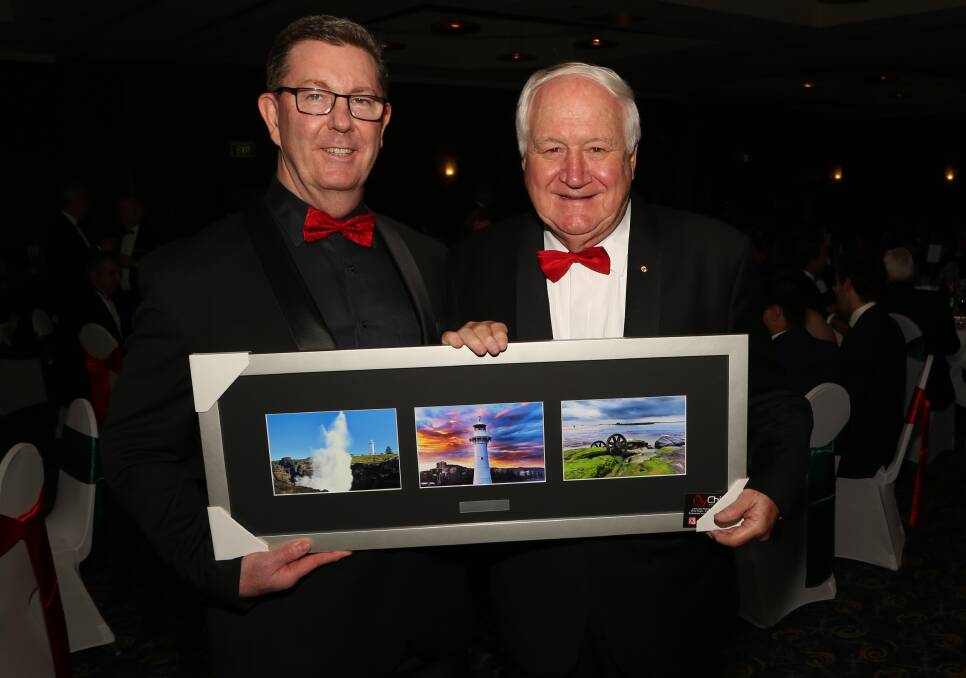 The Illawarra Connection: Graham Lancaster presents TIC Life Member Roger Summerill a thank you gift of some Brad Chilby.imagery at the December networking dinner at the Novotel Wollongong Northbeach. Picture: Greg Ellis.

