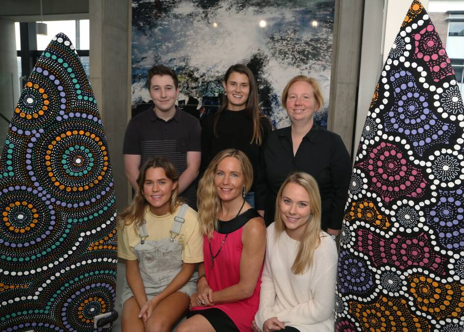 Innovators: Rooland and RooCreate's Corey McGuigan, Lisa Diebold, Jessica Fosler, Suzanne Haddon, Renee Pyers and Alix Tennison next to surfboard art by Zac Bennett-Brook of Saltwater Dreamtime. Picture: Greg Ellis.

